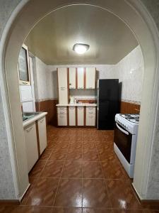 a kitchen with an archway in the middle of it at Gio Apartment in Tbilisi City