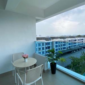 a balcony with a table and chairs and a view at AZ Stayz Homestay in Kajang +8 photos