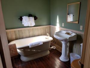 een badkamer met een bad en een wastafel bij Iron Horse Hotel in Blackwater