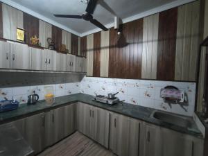 a kitchen with a sink and a counter top at Shri Devbhoomi homestay in Haridwār