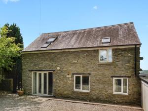 an old stone house with a roof at Pass the Keys Cosy 3 Bedroom Barn Conversion with pool in Tregaron