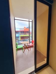 a view of a balcony with a table and chairs at Amazing Rooms in Semporna