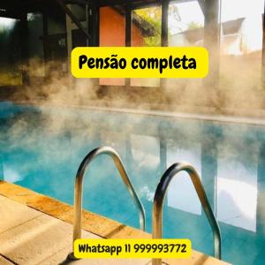 a swimming pool with steam coming out of the water at Pousada Bezerra in Nazaré Paulista