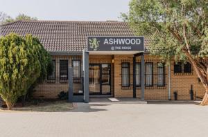 a brick building with a sign that reads ashmoood of the trees at Ashwood The Ridge Boutique Hotel in Bloemfontein