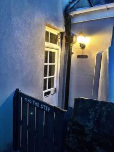 a blue house with a sign in front of a door at TWO BEDROOM Private development & concierge in Plymouth