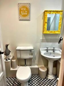 a bathroom with a white toilet and a sink at TWO BEDROOM Private development & concierge in Plymouth