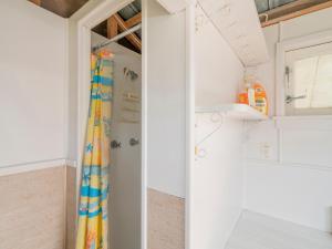 a bathroom with white walls and a shower curtain at Purely Pauanui - Pauanui Holiday Home in Pauanui +20 photos