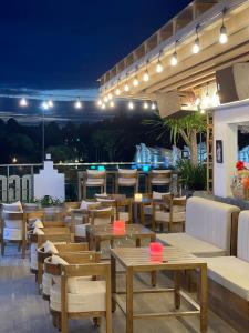 a restaurant with wooden tables and chairs at night at Ngon Avatar Hotel in Pleiku