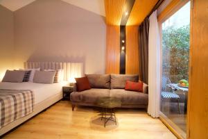 a bedroom with a bed and a couch and a window at Dosso Dossi Hotels Laleli in Istanbul