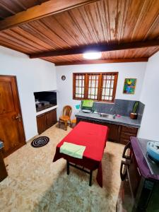 a kitchen with a red table and a sink at Ivory Bloom Resort in Diyatalawa