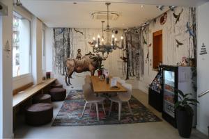 a dining room with a table with a bull on the wall at Hotel Victoria in Strasbourg