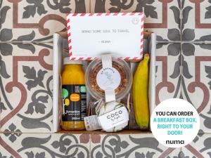 a basket of food and drinks in a box at numa I Lustre Apartments in Barcelona