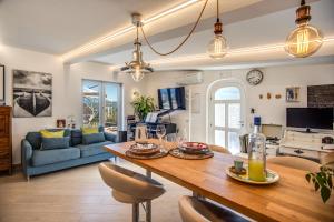 a living room with a table and chairs and a couch at VILLA CARUSO PRIVATE HEATED POOL & SEA VIEW in Sorrento