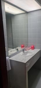 a bathroom with a sink and a large mirror at Paradise Hotel in Tanjung Pinang +60 photos