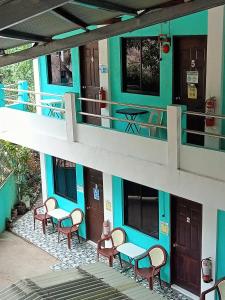 a building with tables and chairs on a balcony at Lang2 place in Coron