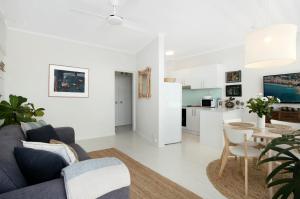 a living room with a couch and a table at Avalon Beachside Apartment in Avalon