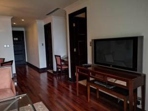 a living room with a large flat screen tv at Apartment at Michelangelo Towers in Johannesburg