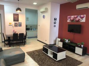 a living room with a couch and a tv at VH Homes, Imago Shopping Mall in Kota Kinabalu