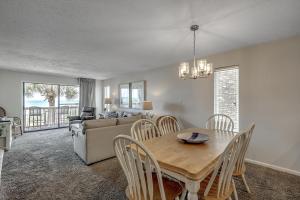 a dining room and living room with a table and chairs at Anchorage II B02 in Myrtle Beach