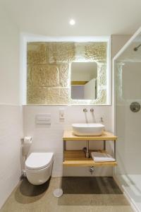 a bathroom with a sink and a toilet at La Fonda in Pontevedra