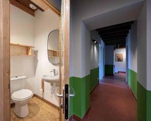 a bathroom with a toilet and a sink at Gite la Tuilerie 46 in Tour-de-Faure