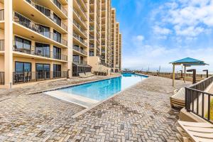 a swimming pool in front of a building at Phoenix X Unit 1212 in Orange Beach