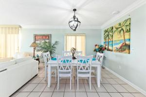 a living room with a white table and chairs at Phoenix X Unit 301 in Orange Beach