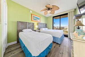 a hotel room with two beds and a balcony at Phoenix X Unit 301 in Orange Beach