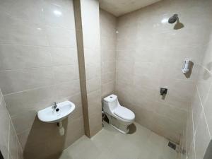 uma casa de banho com um WC e um lavatório em De capitol Hotel Syariah em Patjinongong