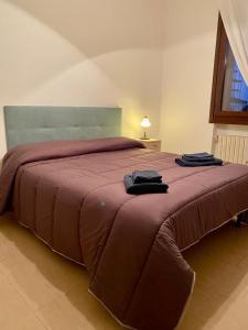 a bedroom with a large bed with a red blanket at Casa Ester in Preganziol