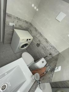 a small bathroom with a toilet and a sink at Gio Apartment in Tbilisi City