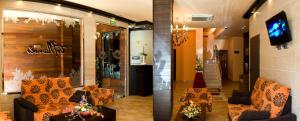 諾雅的住宿－Hotel · Restaurante Asador Tio Manolo，大堂设有两把椅子、一张桌子和一台电视