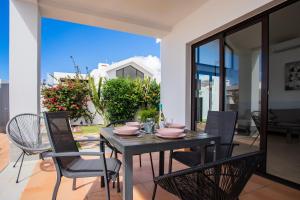 een zwarte eettafel en stoelen op een patio bij Casa Maurizio - Heated Pool, Hot Tub & Hammam in Playa Blanca