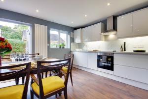 a kitchen with a table and chairs and a dining room at 14 Oxford Mews - 5 Star Living for up to 10 People in Southampton