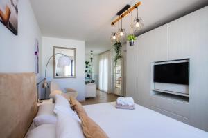 a bedroom with a bed and a flat screen tv at Casa Maurizio - Heated Pool, Hot Tub & Hammam in Playa Blanca +38 photos
