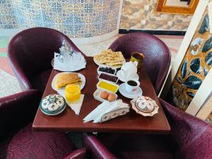 a table with a tray of breakfast food on it at Motel Ain Mersa in Ifrane