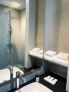 a bathroom with a sink and a mirror at Grand Central Premier in Medan