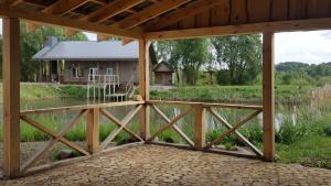a view from the porch of a house with a bridge at Sodyba PILIAKIEMIS in Kurkliškės