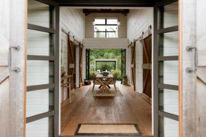 a hallway with a table in a house at The Villa at Bali Garden Matakana in Omaha