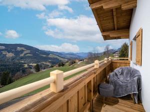 a wooden balcony with a view of a mountain at Haus Gletscherblick in Westendorf