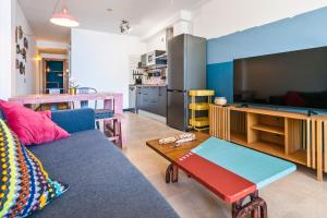 a living room with a couch and a large tv at Cotillo Ocean Waves 1 in Cotillo