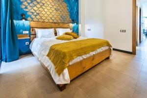 a bedroom with a large bed with a wooden headboard at Cotillo Ocean Waves 1 in Cotillo +18 photos
