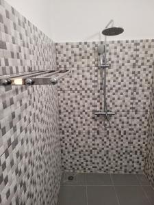 a bathroom with a shower with black and white tiles at Villa MiraMar in Lomé