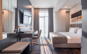 a hotel room with a bed and a desk at Onyx City Center in Tbilisi City