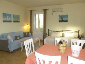 a living room with a couch and a bed and a table at Ktima Pyroessa Apartments - Blue Apartment in Thános
