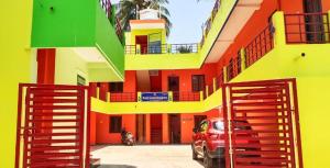 a red car parked in front of a building at Royal Grand Residency in Pondicherry