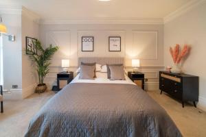 a bedroom with a large bed and two night stands at Westcourt by RMG Apartments in Harrogate
