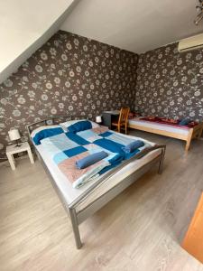 a bedroom with a bed with blue pillows on it at Hermina apartmanház in Budapest