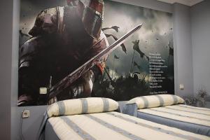 two beds in a room with a poster of aamed at Hostal/Restaurante Fuentevieja in Illana +3 photos