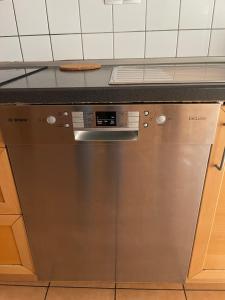 a stainless steel dishwasher in a kitchen at Hamburger Villenviertel, ganzes Haus mit 5 Einbettzimmern,1 Esszimmer in Hamburg +15 photos